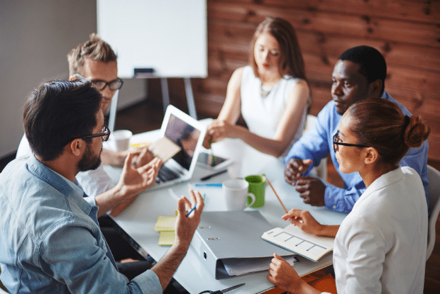 group of employees in a meeting around a table