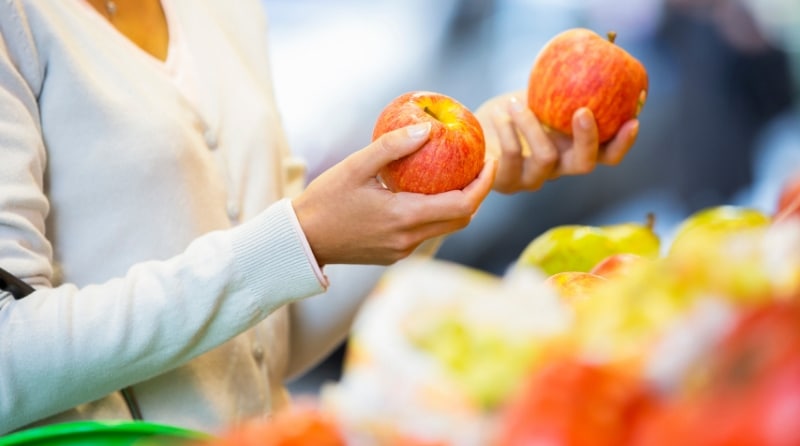 woman holding an apple in each hand