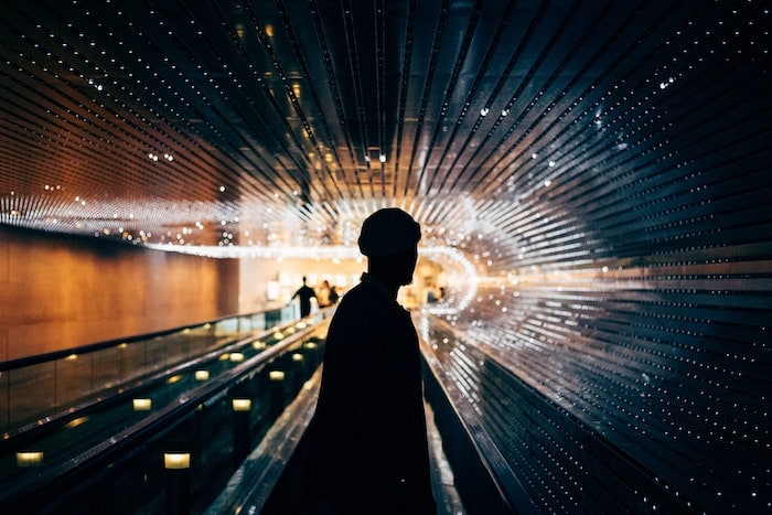 person on a moving conveyor in the dark